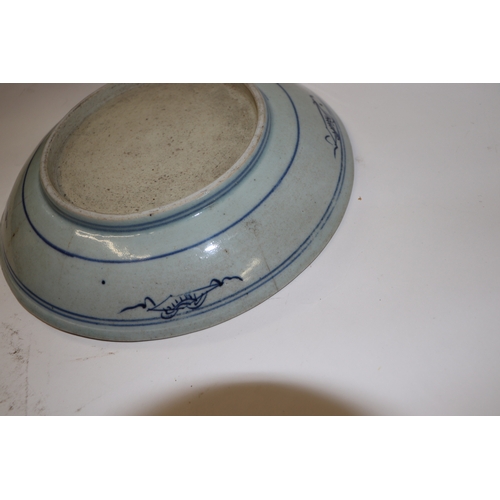 892 - A Chinese blue and white footed bowl decorated with dragons amongst clouds with six character blue m... 