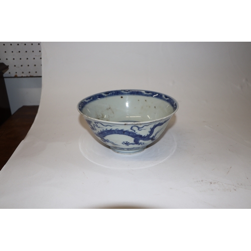 892 - A Chinese blue and white footed bowl decorated with dragons amongst clouds with six character blue m... 