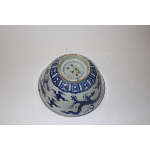 892 - A Chinese blue and white footed bowl decorated with dragons amongst clouds with six character blue m... 