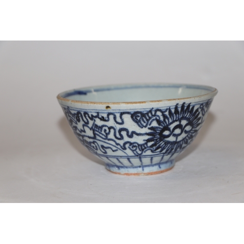 892 - A Chinese blue and white footed bowl decorated with dragons amongst clouds with six character blue m... 