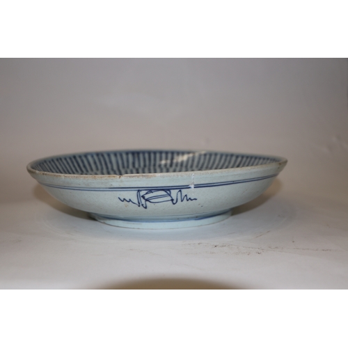 892 - A Chinese blue and white footed bowl decorated with dragons amongst clouds with six character blue m... 