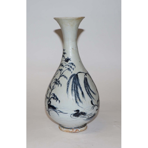 908 - A Chinese blue and white bottle vase decorated with birds and foliage, 25cm high.