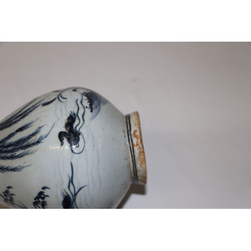 908 - A Chinese blue and white bottle vase decorated with birds and foliage, 25cm high.