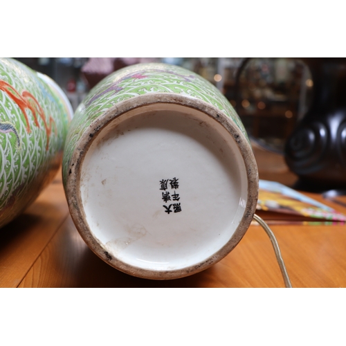 898 - A pair of Chinese famille vert vase table lamps decorated with dragons amongst waves; six character ... 