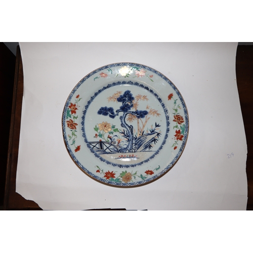 882 - A Chinese famille rose charger decorated with a fir tree and a terrace, 32cm diameter.