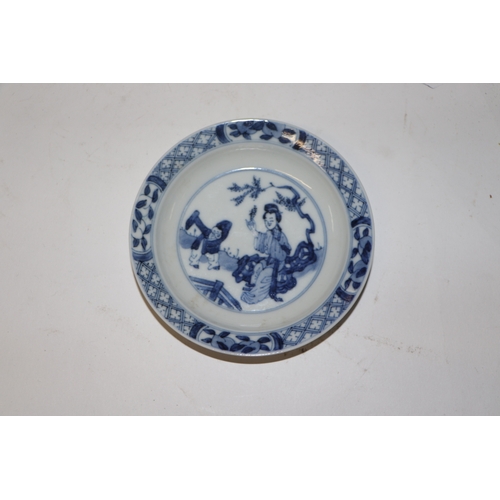 883 - A pair of Chinese blue and white dishes decorated with figures in a garden, four character blue mark... 