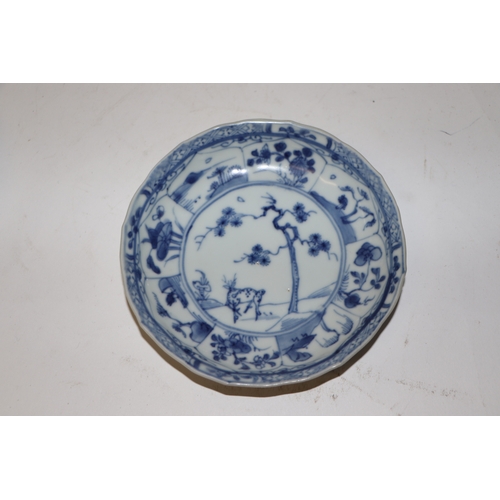 883 - A pair of Chinese blue and white dishes decorated with figures in a garden, four character blue mark... 