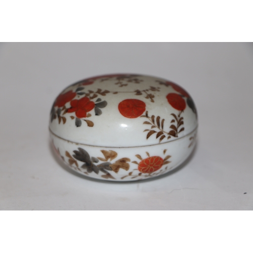 865 - A Chinese famille rose paste box of compressed circular form decorated with young boys playing on a ... 