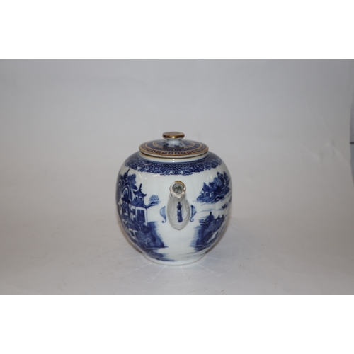 887 - A Chinese blue and white teapot decorated with a river landscape scene, 15cm high.