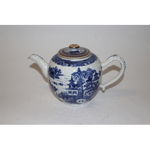 887 - A Chinese blue and white teapot decorated with a river landscape scene, 15cm high.