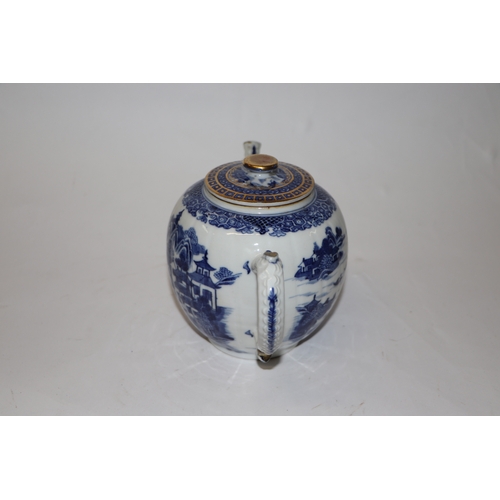 887 - A Chinese blue and white teapot decorated with a river landscape scene, 15cm high.