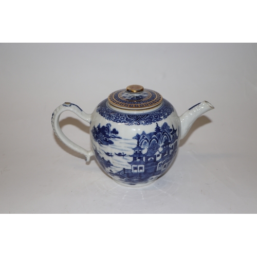 887 - A Chinese blue and white teapot decorated with a river landscape scene, 15cm high.