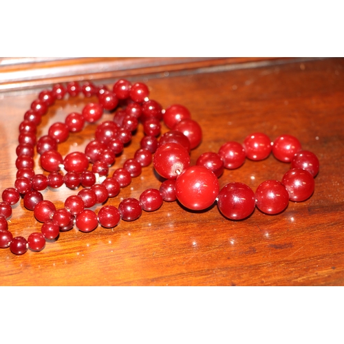 713 - A graduated cherry amber bead necklace, 48g, approx 72cm long.