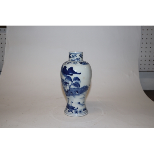 796 - A Chinese blue & white baluster vase decorated in relief with a landscape, four character mark to th... 