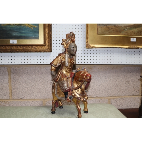 886 - A pair of Chinese giltwood figures on horseback, 40cm high.