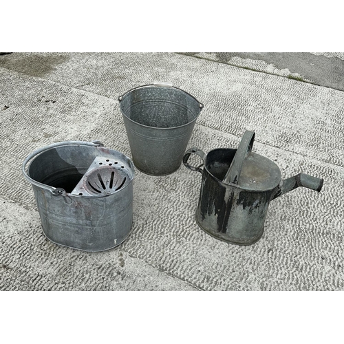 10 - A galvanised bucket, a galvanised mop bucket together with a water can. (3)