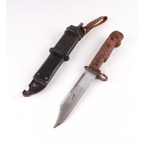 108 - A Russian AKM-type brown bakelite handled bayonet with integral wire cutter in its black metal scabb... 