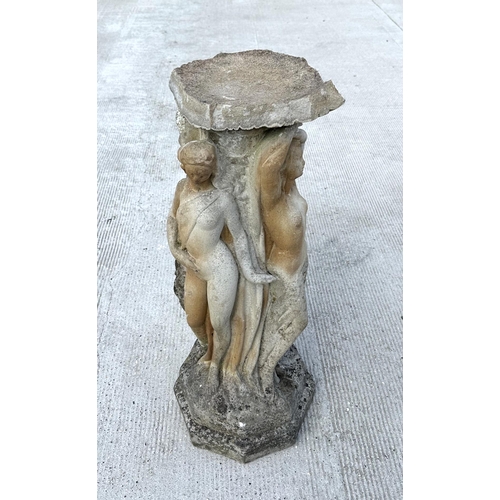 11 - A weathered reconstituted stone pedestal depicting the three graces.