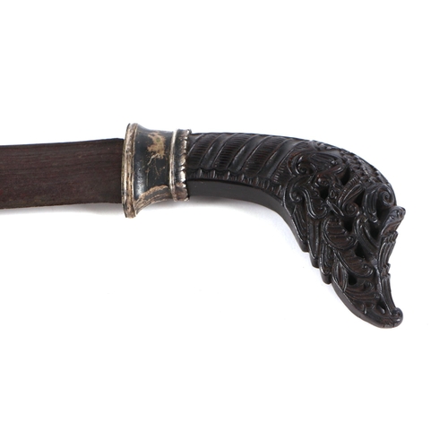 123 - A Pedang sword of Islamic Sumatra, the finely carved horn hilt with silver alloy mounts and slightly... 