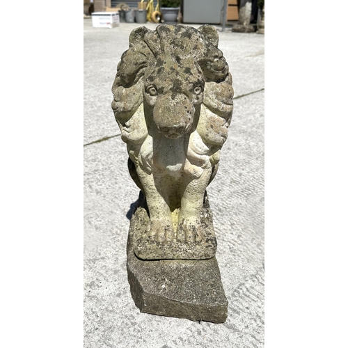 13 - A group of three reconstituted stone seated lions, 44cm high. (3)