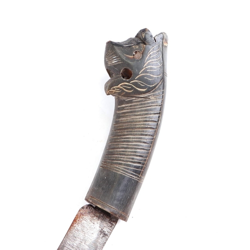 133 - An Asian dagger with horn handle and stylised lion terminal, in a metal mounted lacquered scabbard, ... 