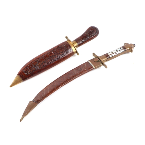 138 - An Indian dagger with mother of pearl inlaid brass handle and steel curved blade with engraved decor... 