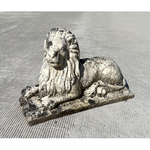 14 - A well weathered marble figure of a recumbent lion, 60cm long, 22cm deep and 40cm high.