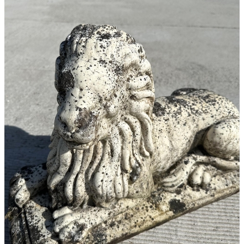 14 - A well weathered marble figure of a recumbent lion, 60cm long, 22cm deep and 40cm high.