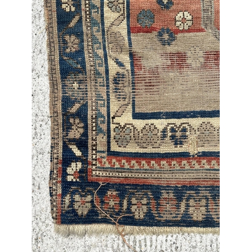 143 - A Turkish prayer rug on a pale blue ground and foliate borders, probably late 19th century, 103 by 1... 