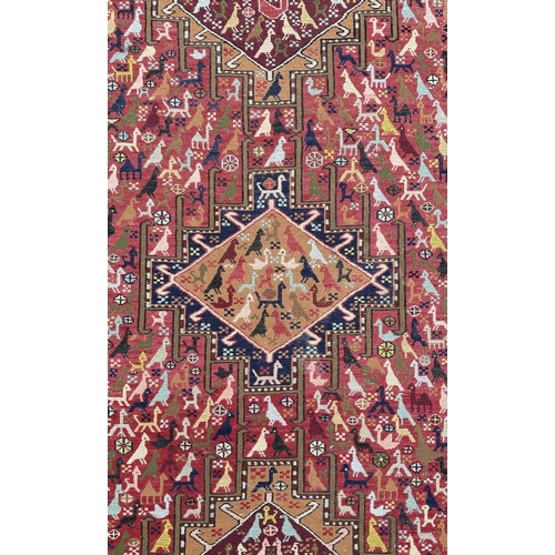 145 - A Persian flatweave rug decorated with a multitude of stylised animals within a geometric border, on... 