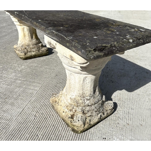 15 - A garden bench with reconstituted stone pedestals and a slate seat, 128cm wide.