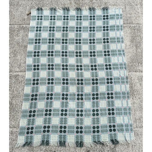 151 - A Welsh woollen blanket with geometric design on a blue ground, 154cm by 220cm.