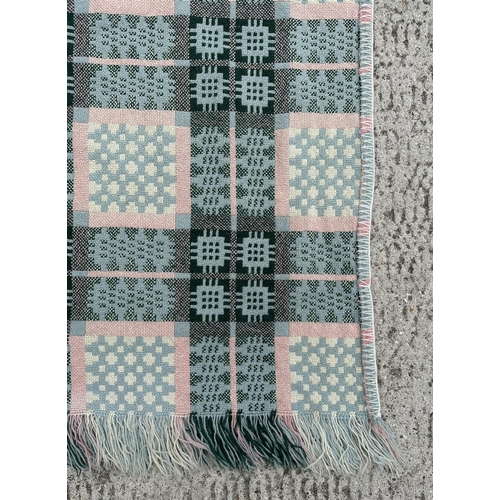 151 - A Welsh woollen blanket with geometric design on a blue ground, 154cm by 220cm.