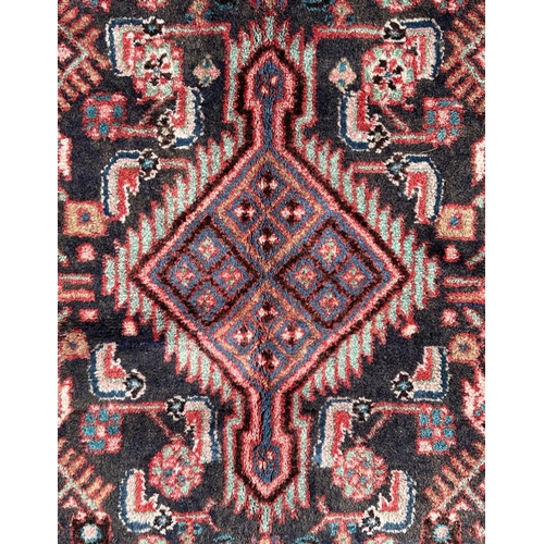 156 - A Persian Hamadan runner on a red ground, 280 by 80cms (333).