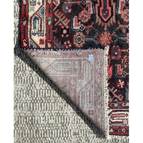 156 - A Persian Hamadan runner on a red ground, 280 by 80cms (333).