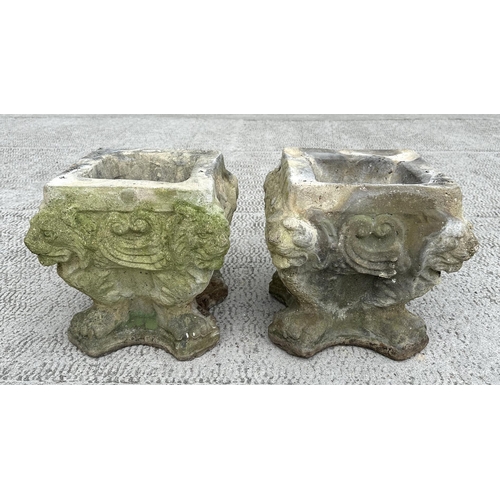 16 - A pair of well weathered reconstituted stone planters, 34cms wide by 34cms high (2).