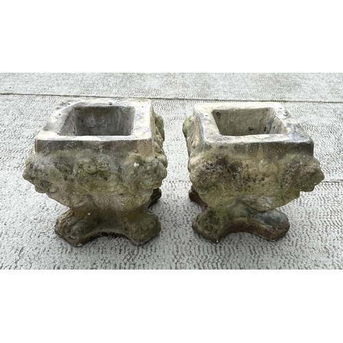 16 - A pair of well weathered reconstituted stone planters, 34cms wide by 34cms high (2).