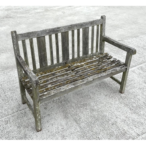 20 - A well weathered teak slatted garden bench, 122cm wide.