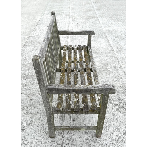 20 - A well weathered teak slatted garden bench, 122cm wide.