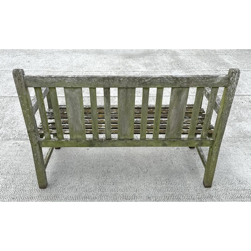 20 - A well weathered teak slatted garden bench, 122cm wide.