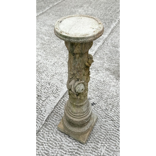 21 - A well weathered reconstitiuted stone bird bath, the column having rose decoration, 28cm diameter.