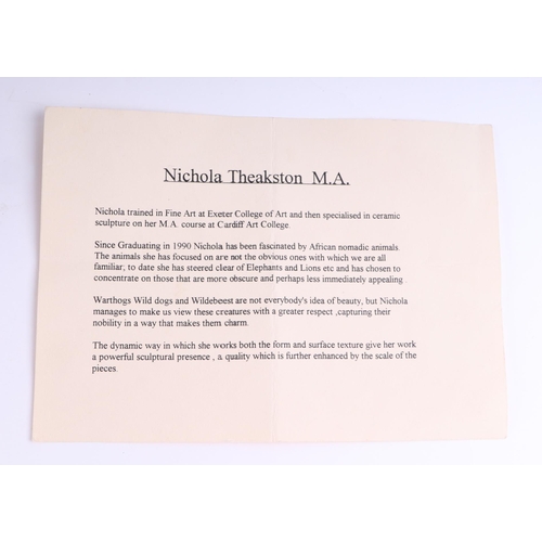 378 - Nichola Theakston MA (modern British) - a ceramic reclining wildebeest sculpture, 75cm wide.