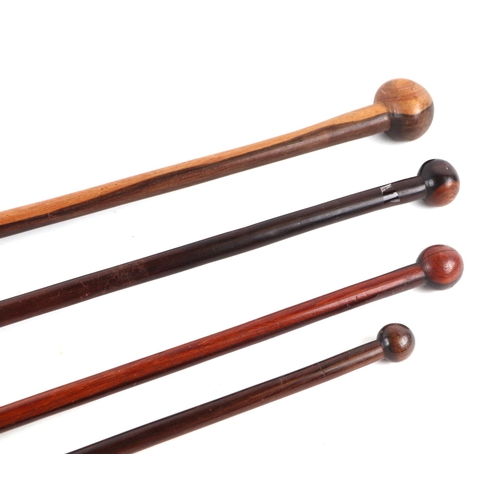 411 - A group of African hardwood knobkerrie type walking canes, largest 92cm long. (4)