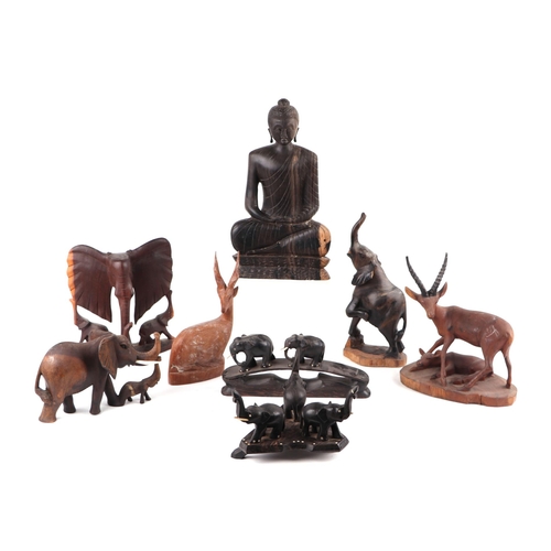 417 - A large quantity of Asian and ethnographic wooden carvings depicting animals, figure and panels.