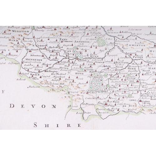 44 - John Speed - a hand coloured map of Dorsetshyre with armorials and vignette of Dorchester, 57 by 43c... 