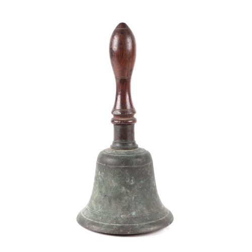 520 - An 18th century bronze pestle and mortar, 12cms high; together with a hand bell with turned wooden h... 