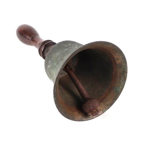 520 - An 18th century bronze pestle and mortar, 12cms high; together with a hand bell with turned wooden h... 