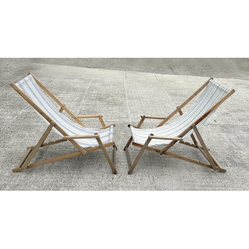 7 - A pair of traditional canvas deck chairs.