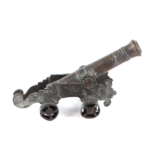 78 - A cast bronze Malay cannon on carriage, 26cm long.