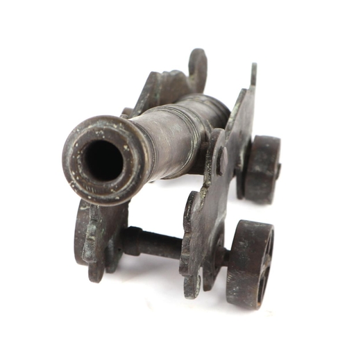 78 - A cast bronze Malay cannon on carriage, 26cm long.